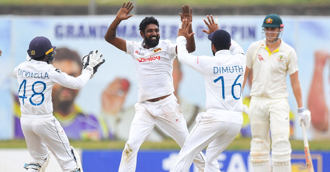 Prabath Jayasuriya, second left, celebrates with teammates after taking the wicket of Marnus Labuschagne. Photo: AFP/Ishara S Kodikara