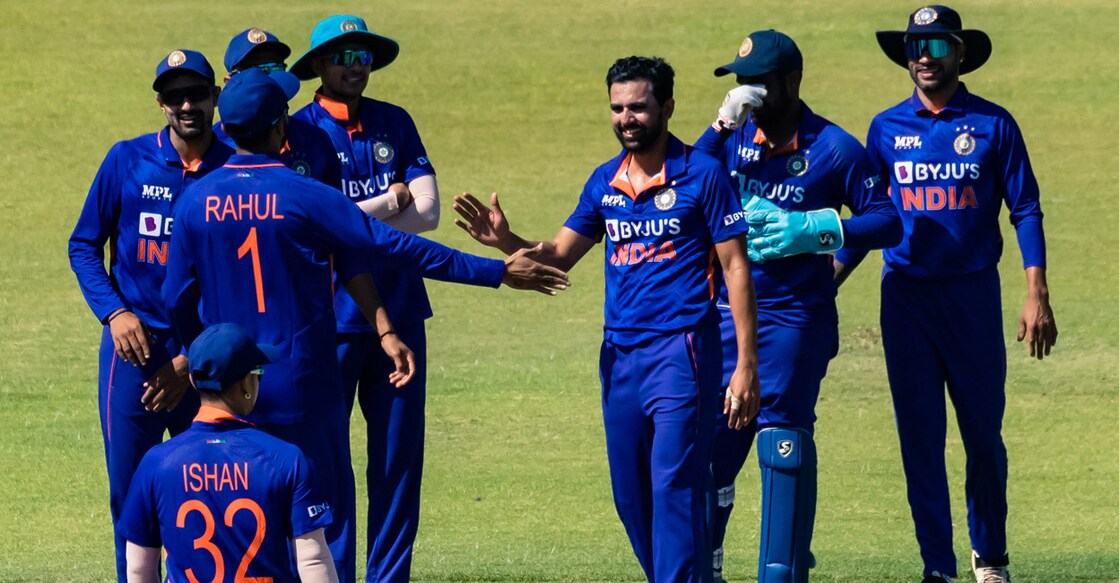 Deepak Chahar, third right, celebrates with teammates after picking up a wicket. Photo: AFP/Jekesai Njikizana