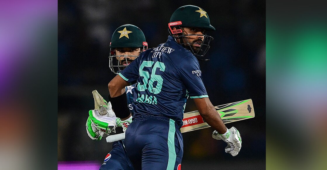 Pakistan's captain Babar Azam (right) and teammate Mohammad Rizwan run between the wickets during the second T20I against England at the National Cricket Stadium in Karachi on Thursday. Photo: AFP/ Asif Hassan 