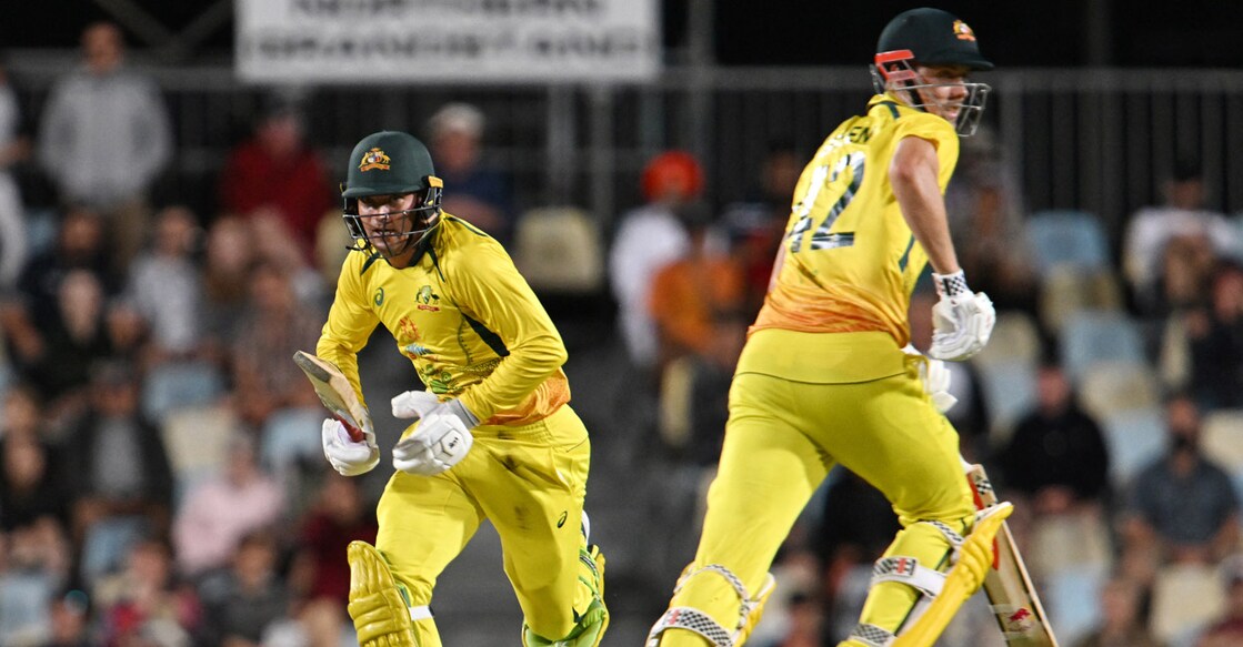 Alex Carey and Cameron Green pick up a run. Photo: AFP/Saeed Khan