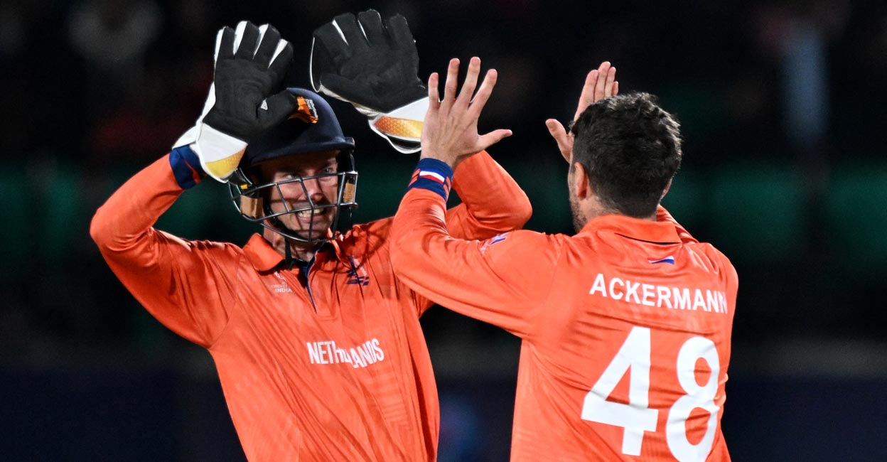 Netherlands captain Scott Edwards celebrates with Colin Ackermann after the dismissal of Quinton de Kock. Photo: AFP/Money Sharma