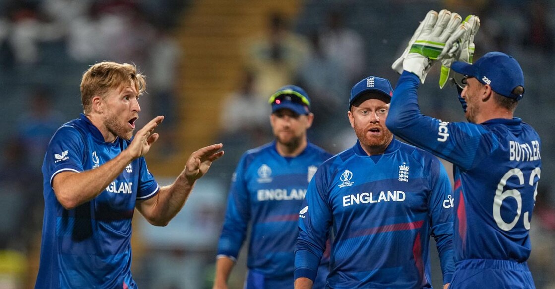 England's David Willey, left, celebrates with teammates after taking the wicket of Netherlands' Colin Ackermann. Photo: PTI/Shashank Parade