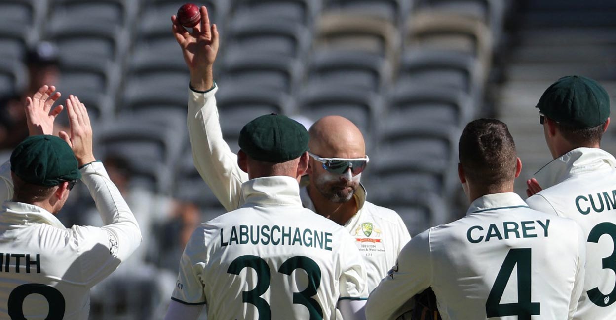 Nathan Lyon displays the ball after picking up his 500th Test wicket. Photo: AFP/Colin Murty