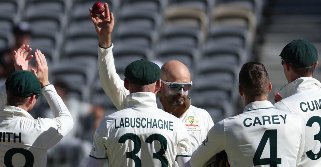 Nathan Lyon displays the ball after picking up his 500th Test wicket. Photo: AFP/Colin Murty
