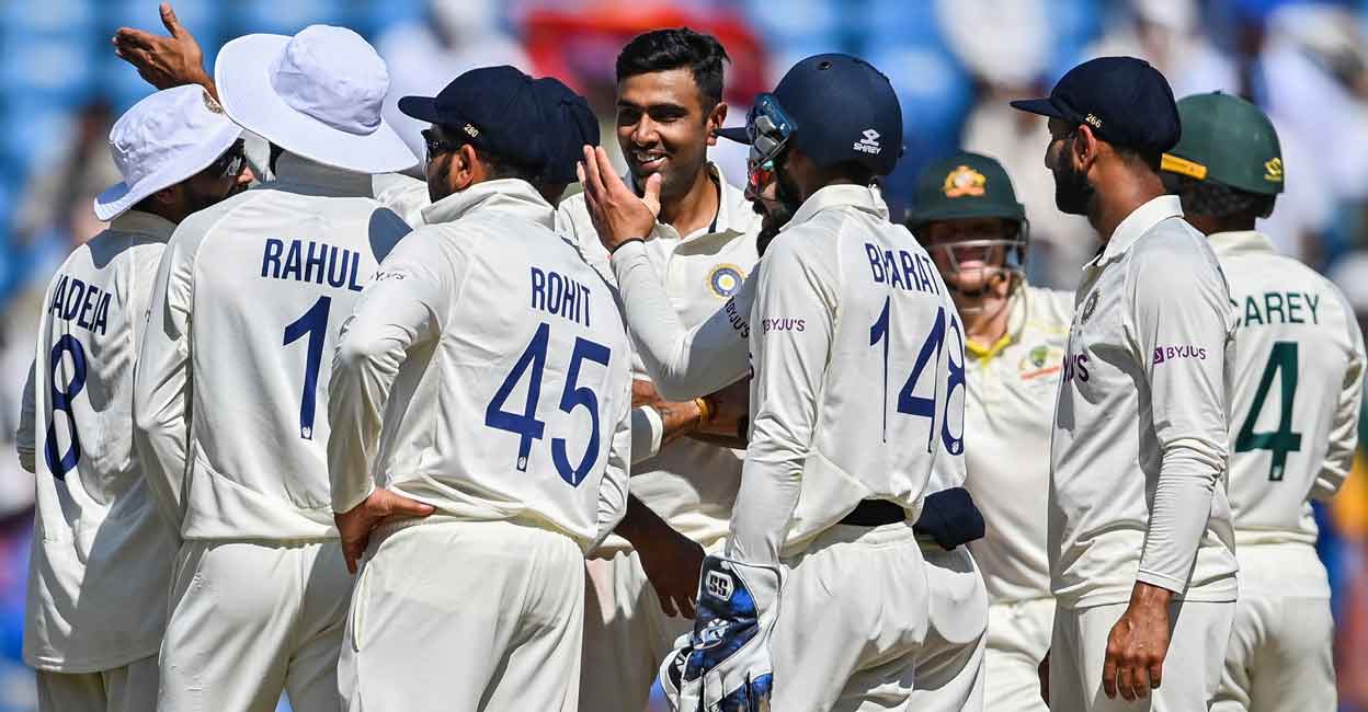 Ravichandran Ashwin, centre, celebrates with teammates after picking up his fifth wicket. Photo: AFP/Indranil Mukherjee 