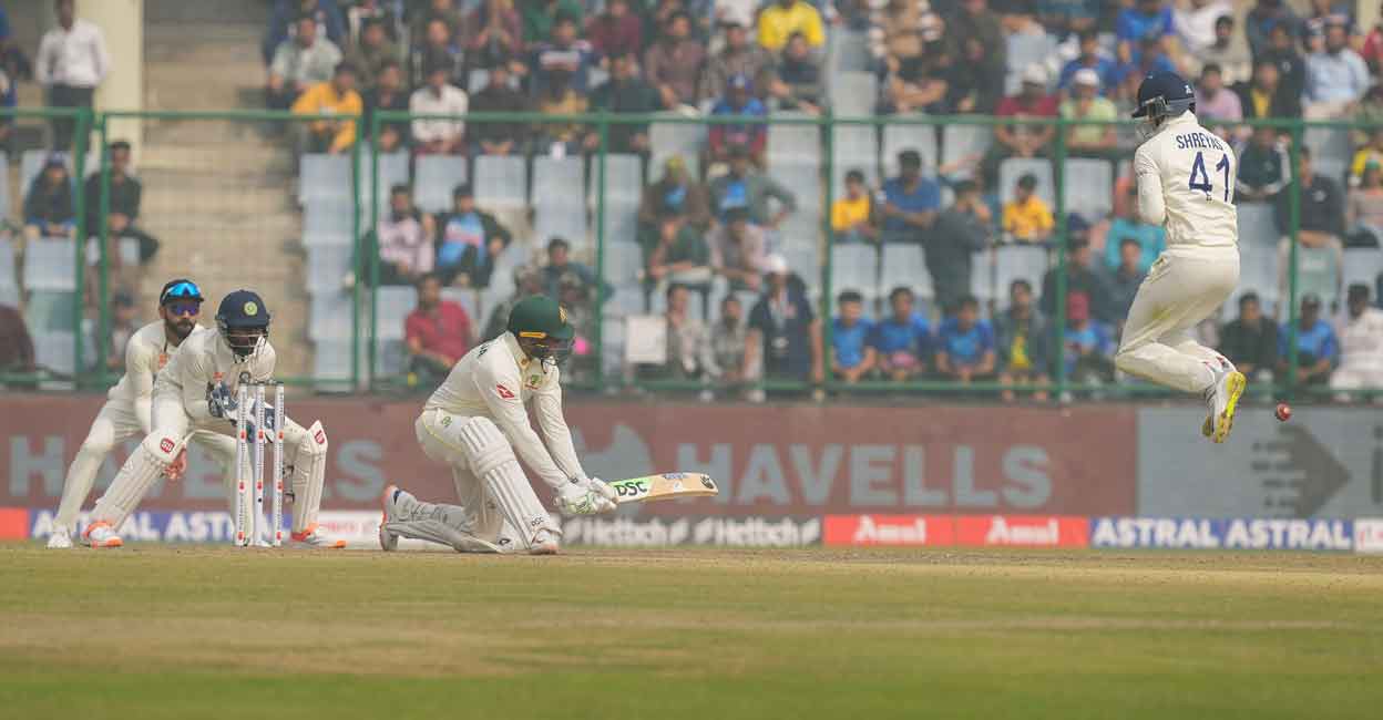 Usman Khawaja plays a reverse sweep. Photo: PTI/Arun Sharma