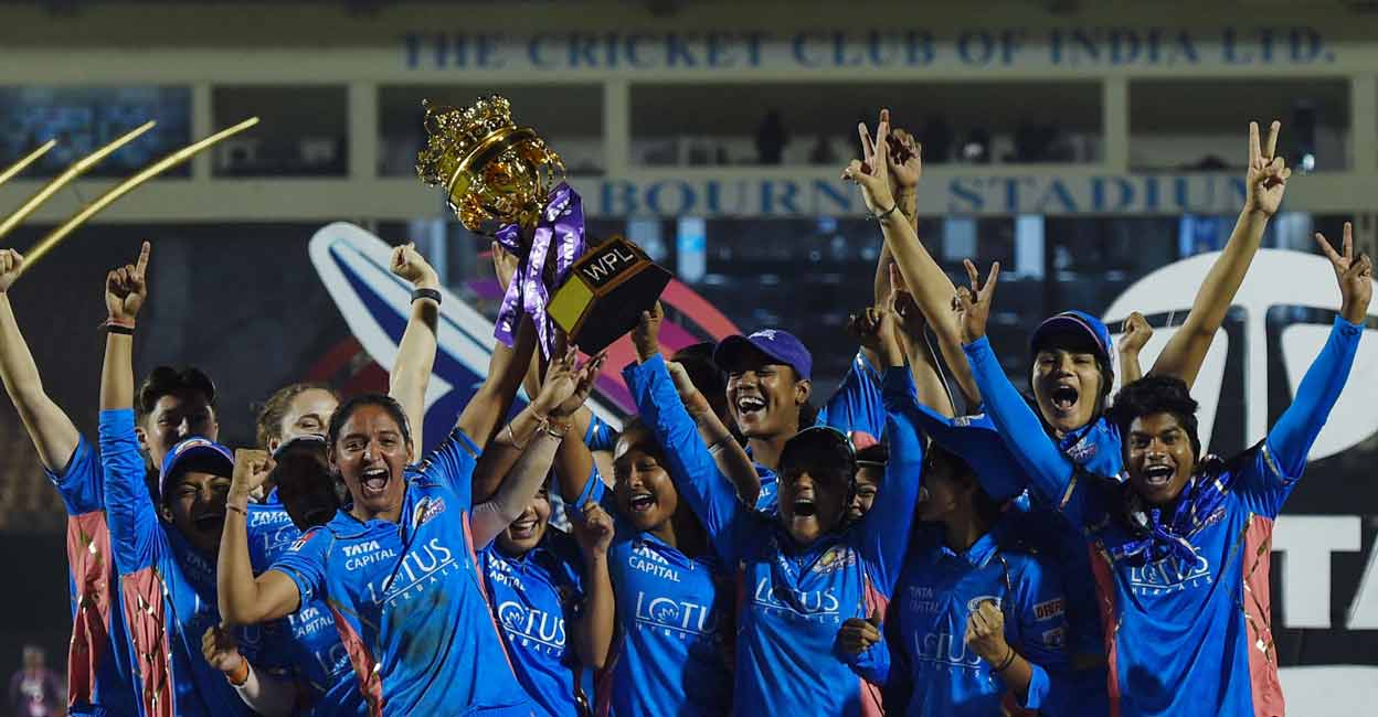 CRICKET-IND-WPL-T20-MUMBAI-DELHI Mumbai Indians' players pose with the trophy after winning the 2023 Women's Premier League (WPL) final against Delhi Capitals at the Brabourne Stadium in Mumbai on Sunday. Photo: AFP/Punit Paranjpe