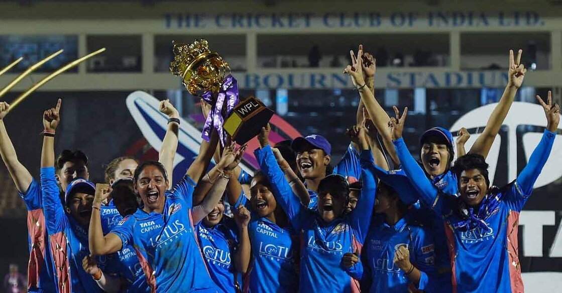 Mumbai Indians' players pose with the trophy after winning the 2023 Women's Premier League (WPL) final against Delhi Capitals at the Brabourne Stadium in Mumbai on Sunday. Photo: AFP/Punit Paranjpe