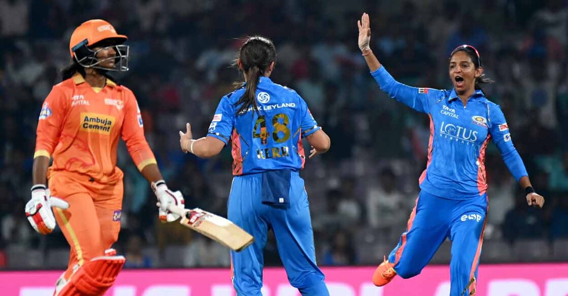 Mumbai Indians' captain Harmanpreet Kaur (right) celebrates with Amelia Kerr after the dismissal of Gujarat Giants' Sneh Rana during the 2023 Women's Premier League (WPL) Twenty20 match at the DY Patil Stadium in Navi Mumbai on Saturday. Photo: PTI 