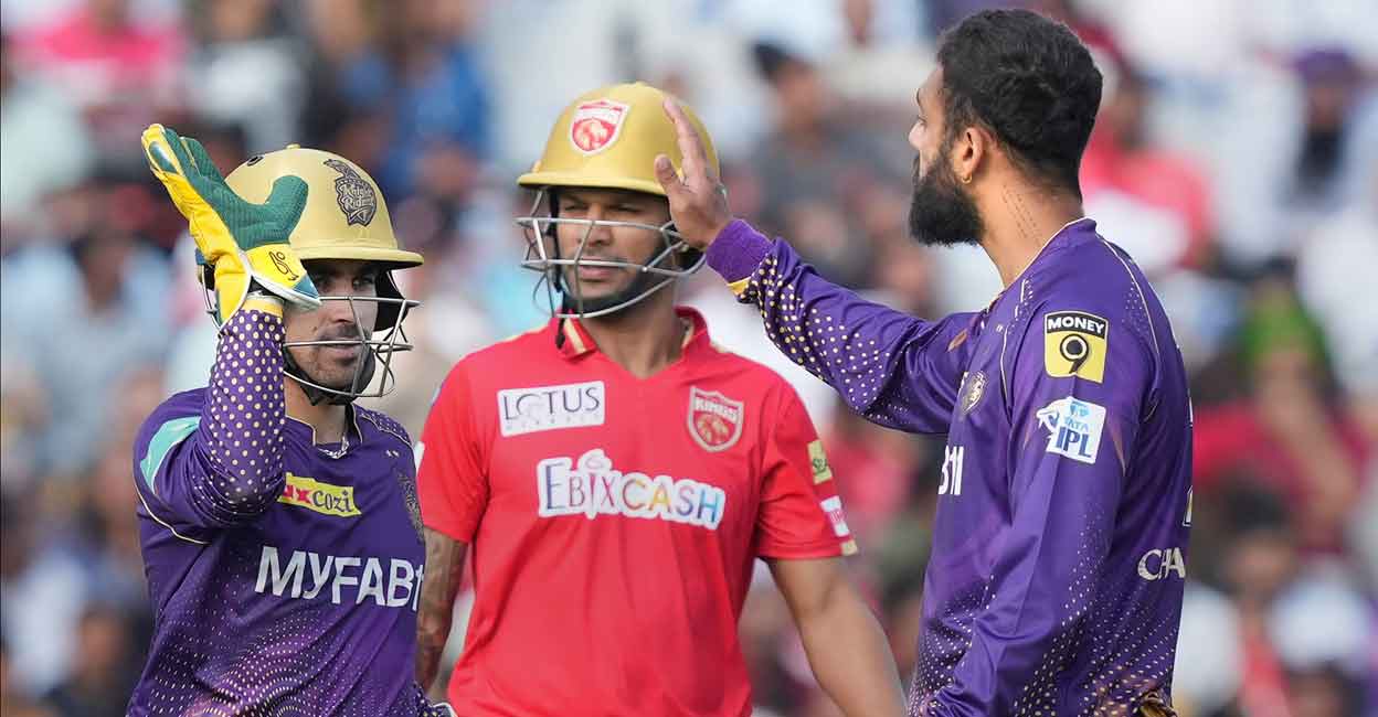 Varun Chakravarthy, right, ended Punjab Kings captain Shikhar Dhawan's stay at the wicket. Photo: PTI/Kamal Kishore
