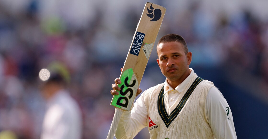 Australia's Usman Khawaja acknowledges the crowd as he walks off the field at stumps after scoring 126 not out. Photo: Reuters/Andrew Couldridge