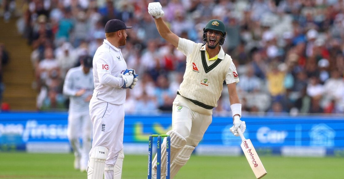 Australia's Pat Cummins celebrates after Australia win the first test by 2 wickets as England's Jonny Bairstow looks on. Photo: Paul Childs/Reuters