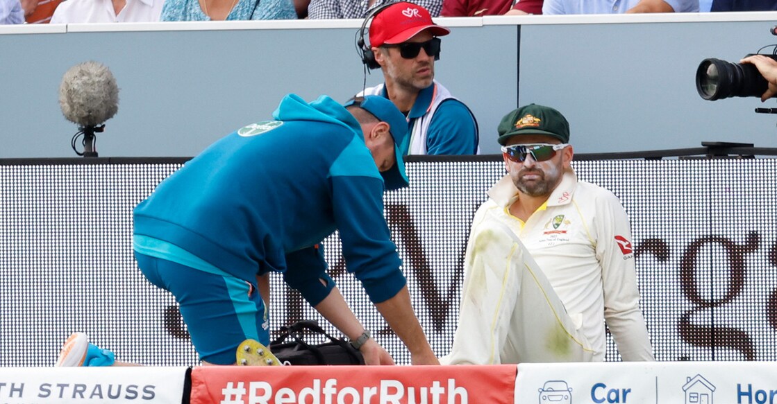 Australia's Nathan Lyon receives medical attention after sustaining the calf injury. File photo:  Action Images via Reuters/Peter Cziborra