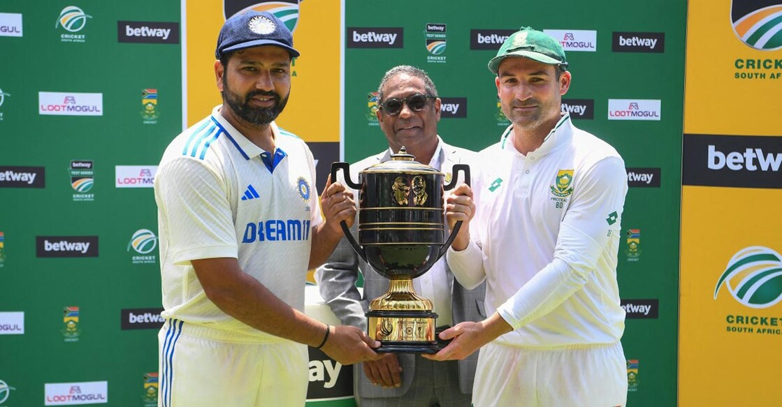 Rohit Sharma and Dean Elgar pose with the trophy after the series ended 1-1. Photo: AFP/Rodger Bosch