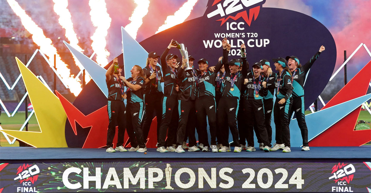 New Zealand captain Sophie Devine lifts the trophy as she celebrates with teammates after winning the Women's T20 World Cup. Photo: Reuters/Satish Kumar