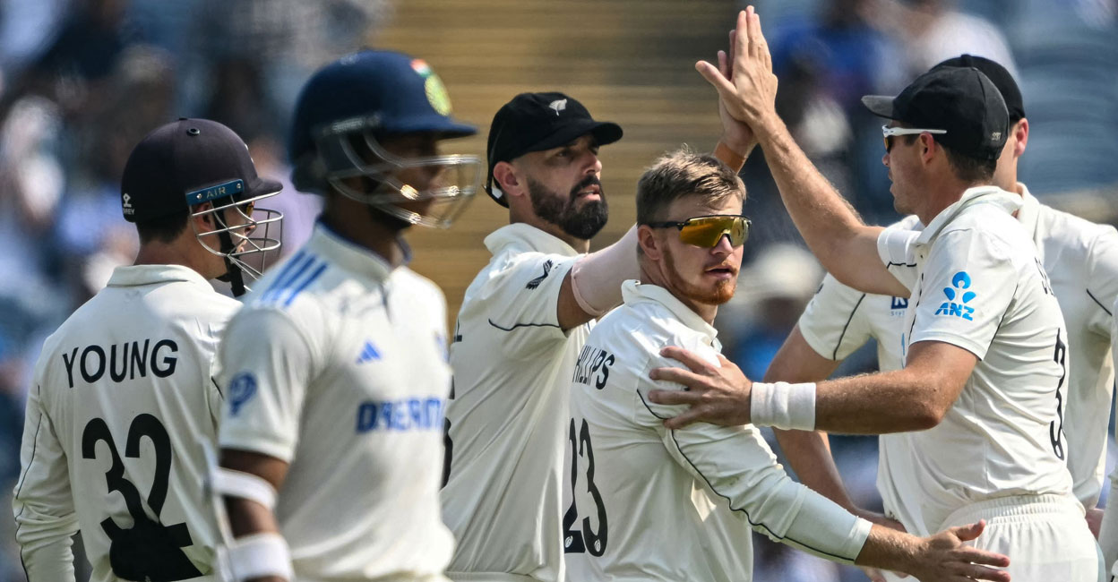 New Zealand's Glenn Phillips (2R) looks at India's Yashasvi Jaiswal (2L) as he celebrates after taking his wicket during the second day of the second Test at the Maharashtra Cricket Association Stadium in Pune on October 25, 2024. Photo: AFP/ Punit Paranjpe