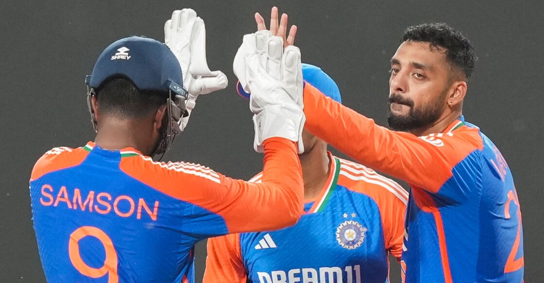 India's Varun Chakravarthy and Sanju Samson celebrate the wicket of Bangladesh's Jaker Ali during the first T20I in Gwalior on Sunday. Photo: PTI