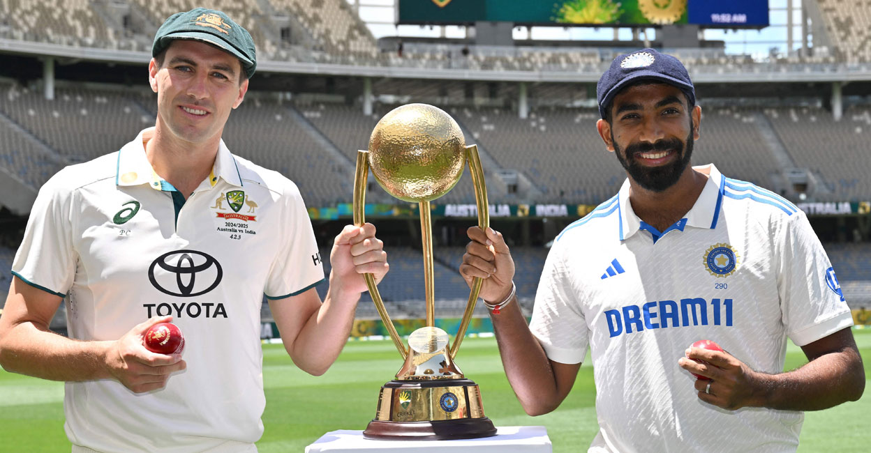 CRICKET-AUS-IND Pat Cummins and Jasprit Bumrah, captains of Australia and India respectively pose with the trophy at Optus Stadium in Perth on November 21, 2024. Photo: AFP/ Saeed Khan