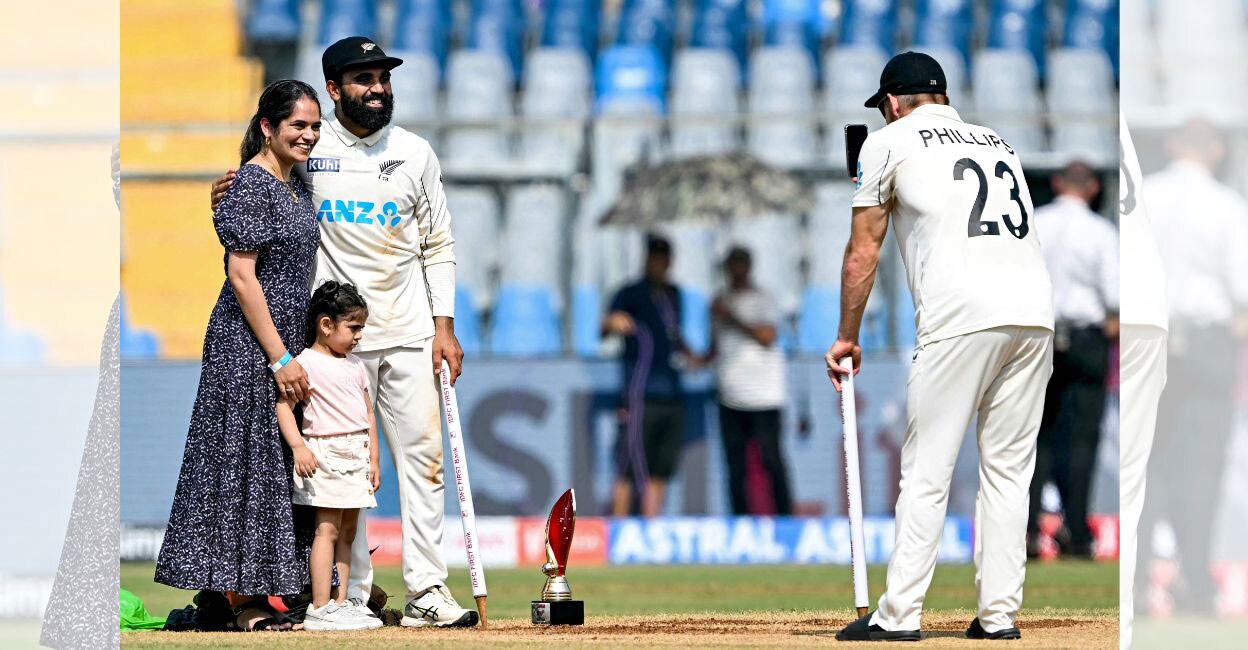 New Zealand's Glenn Phillips clicks a family photograph for Ajaz Patel after their win against India in the third and final Test cricket at the Wankhede Stadium in Mumbai on November 3, 2024. Photo: AFP/ Indranil Mukherjee