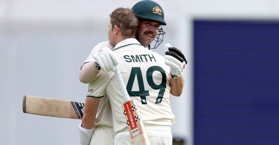 Australia's Steve Smith celebrates reaching his century with team mate Travis Head on day two of the third cricket Test match between Australia and India at The Gabba in Brisbane. Photo: AFP