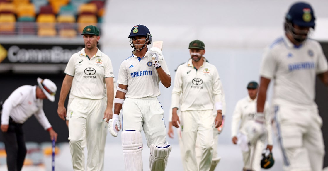 India's Yashasvi Jaiswal (centre) walks off the ground with Australian players due to a rain delay on day five of the third Test at The Gabba in Brisbane on December 18, 2024. Photo: AFP/ David Gray