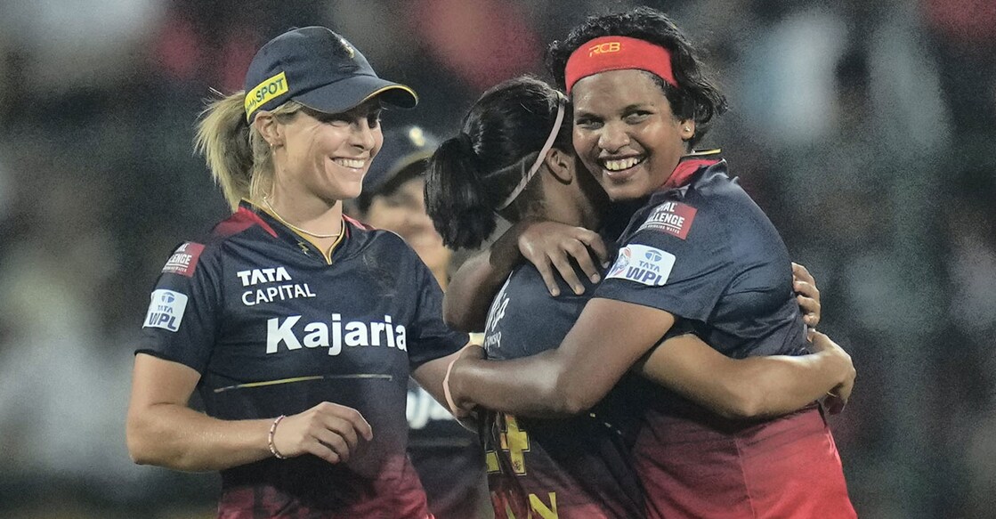 Royal Challengers Bangalores Asha Shobana celebrates with teammates after taking the wicket of UP Warriorz' Vrinda Dinesh during a Womens Premier League match at M Chinnaswamy Stadium in Bengaluru on Saturday. Photo: PTI
