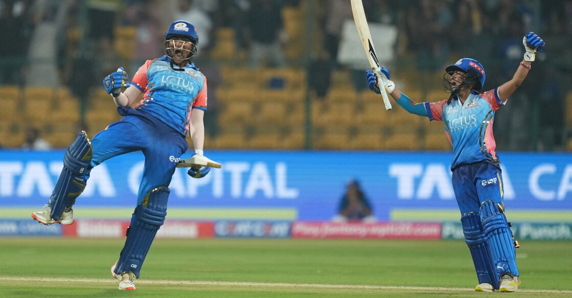 Mumbai Indians' Kerala player Sajana S (left) and Amanjot Kaur celebrate beating Delhi Capitals in the WPL at the M Chinnaswamy Stadium in Bengaluru on Friday. Photo: PTI