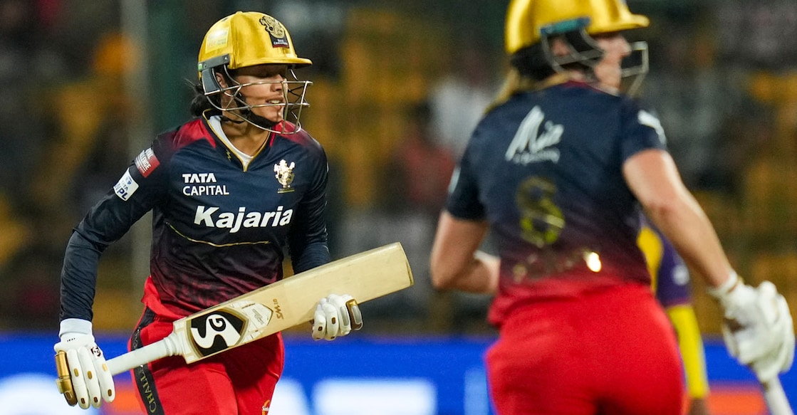 Royal Challengers Bangalore's batters Smriti Mandhana and Ellyse Perry run between the wickets during the Women's Premier League (WPL) match against UP Warriorz at M Chinnaswamy stadium in Bengaluru on Monday. Photo: PTI