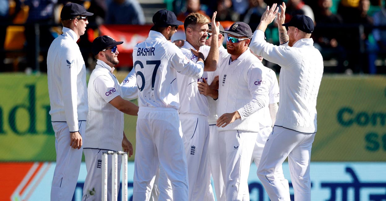 CRICKET-TEST-IND-ENG James Anderson celebrates with teammates after taking his 700th Test wicket. Photo: Reuters/Adnan Abidi