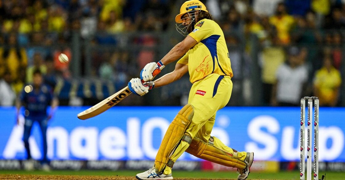 M S Dhoni hits a six. Photo: AFP/Indranil Mukherjee