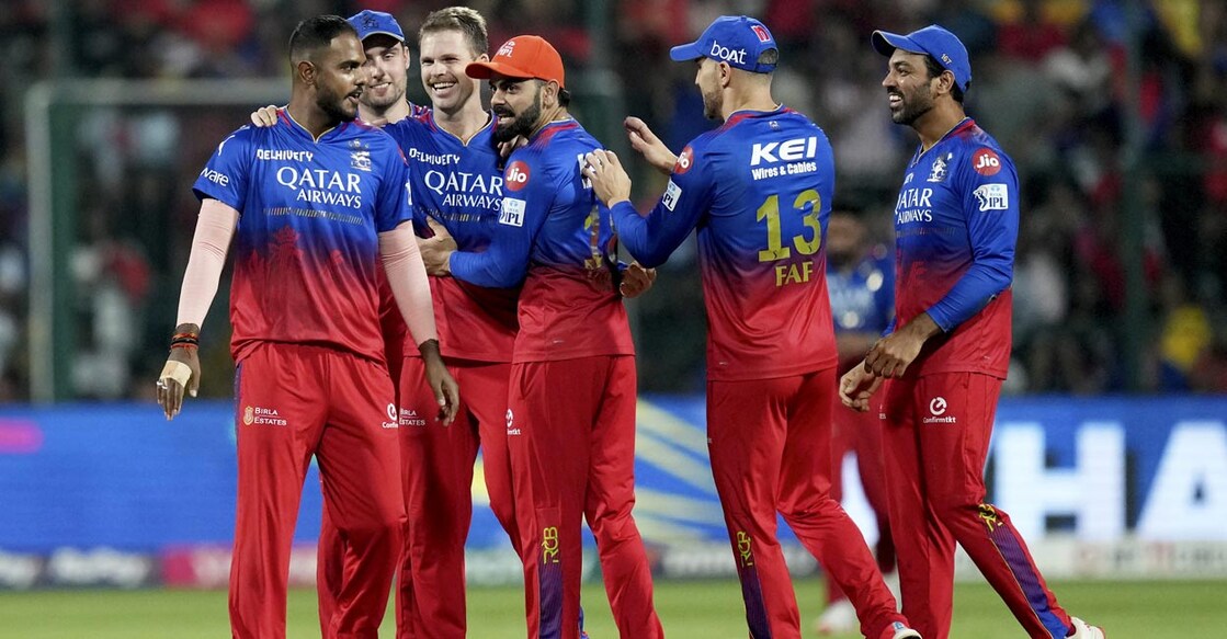 RCB players celebrate a wicket. Photo: PTI/Shailendra Bhojak