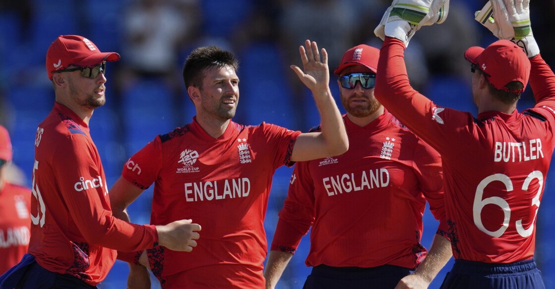 England T20 world cup England's Mark Wood highs five with teammates after taking the wicket of Oman's Ayaan Khan. Photo: AP/PTI.