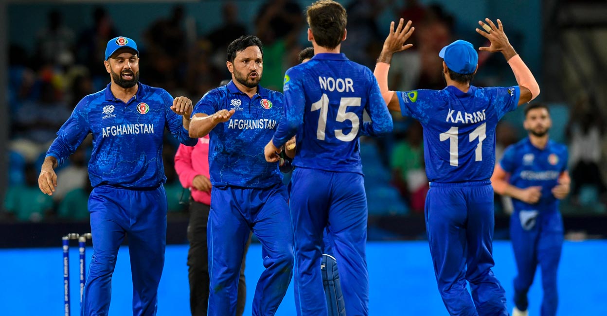Gulbadin Naib, second left, played a key role in Afghanistan's victory. Photo: AFP/Randy Brooks
