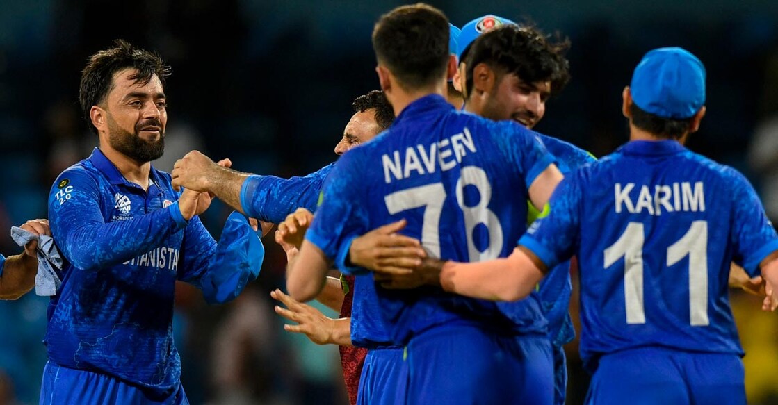 Afghanistan captain Rashid Khan, left, and teammates celebrate their win. Photo: AFP/Randy Brooks