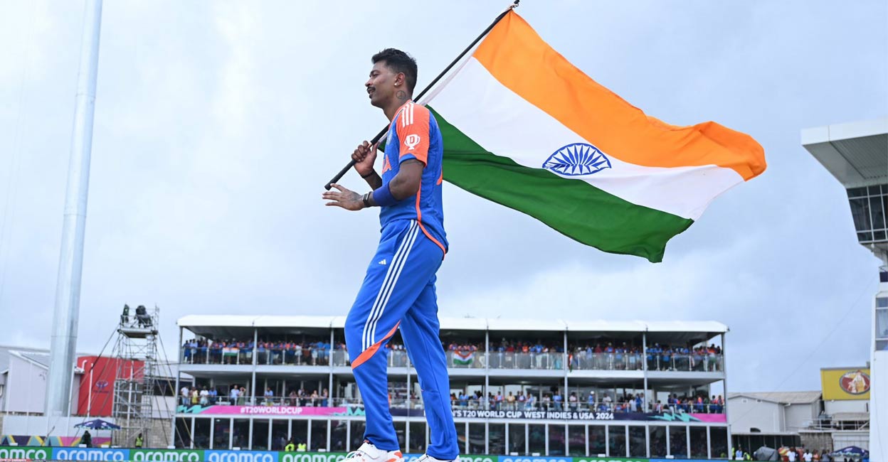Indias Hardik Pandya waves the Indian tricolour after winning the T20 World Cup 2024, at the Kensington Oval, in Bridgetown, Barbados. Photo: PTI. 