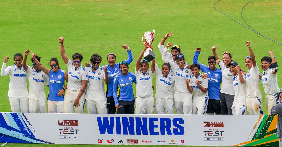 India Women players celebrate with the winners' trophy after defeating South Africa on the 4th and last day of the one-off Test cricket match at MA Chidambaram Stadium, in Chennai on Monday. Photo: PTI