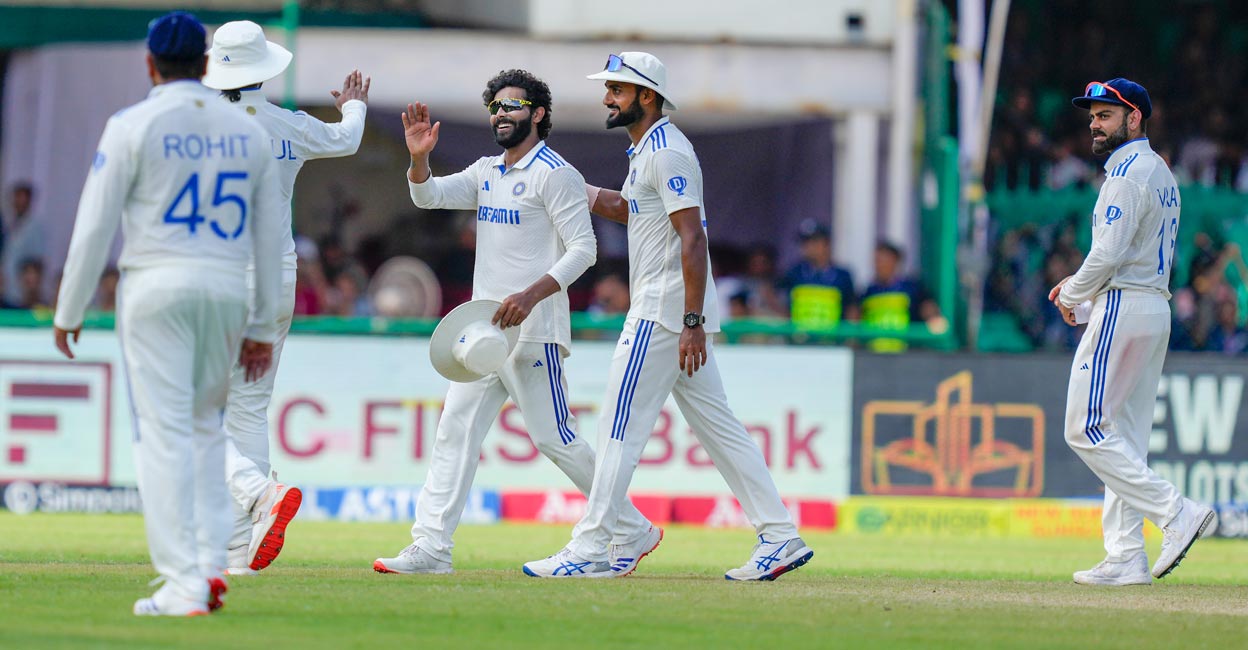 Ravindra Jadeja, centre, celebrates with teammates after reaching the milestone. Photo: PTI/Vijay Verma 