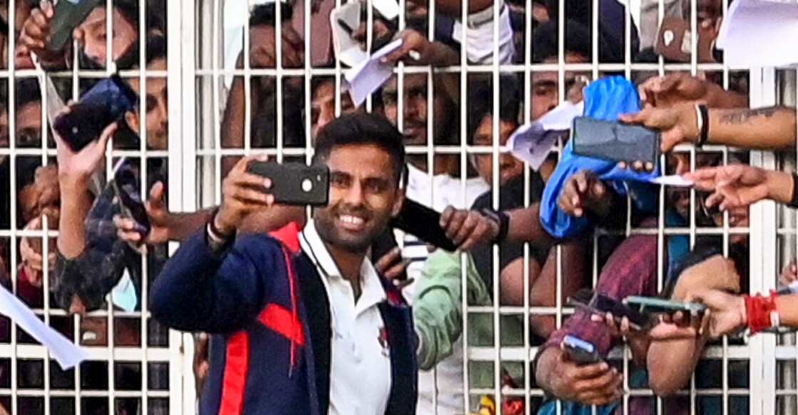 PTI02_08_2025_000399A Suryakumar Yadav takes a selfie with fans at the Eden Gardens in Kolkata. Photo: PTI