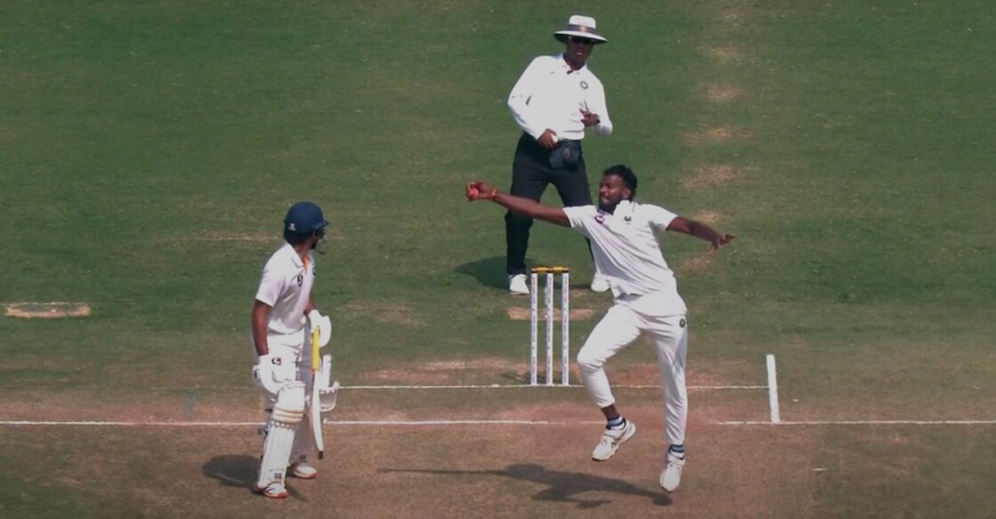 M D Nidheesh takes a smart return catch to claim his 100th first-class wicket. Photo: Screengrab/JioCinema