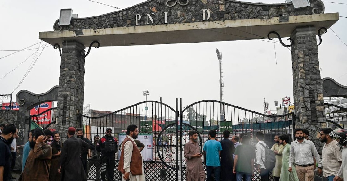rawalpindi-stadium People gather outside a street near the Rawalpindi cricket stadium after an alleged drone was shot down in Rawalpindi. Photo: AFP