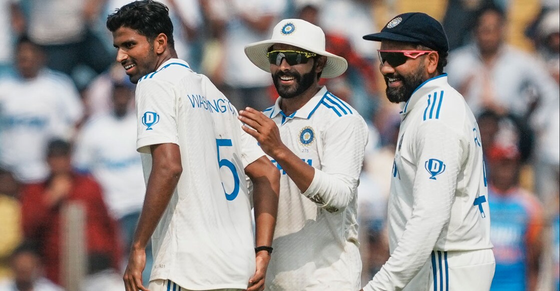 India's Washington Sundar celebrates with captain Rohit Sharma and Ravindra Jadeja after taking the wicket of New Zealand's Rachin Ravindra on the first day of the second Test at the Maharashtra Cricket Association Stadium in Pune on Thursday. Photo: PTI