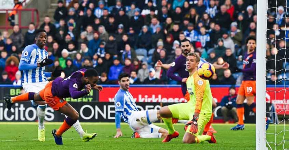 Man City stroll past Huddersfield to keep pace at the top