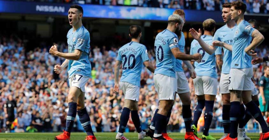 Man City back on top after tense win over Spurs