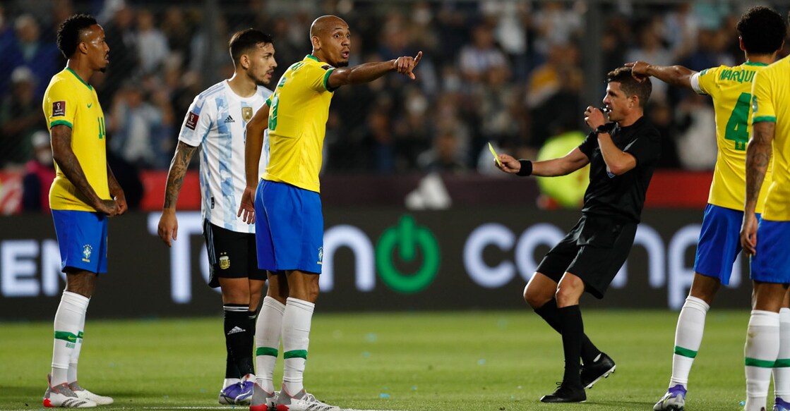 Brazil's Edenilson remonstrates with referee Andres Cunha. Photo: Reuters