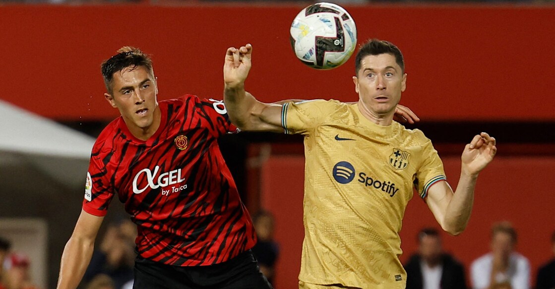 Antonio Raillo and Robert Lewandowski, right, fight for possession. Photo: Reuters/Vincent West
