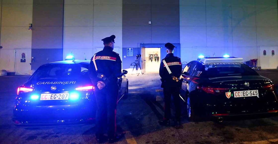 Police officers stand guard near the site where several people were injured in a stabbing incident at Assago near Milan. Photo: Reuters/Flavio Lo Scalzo
