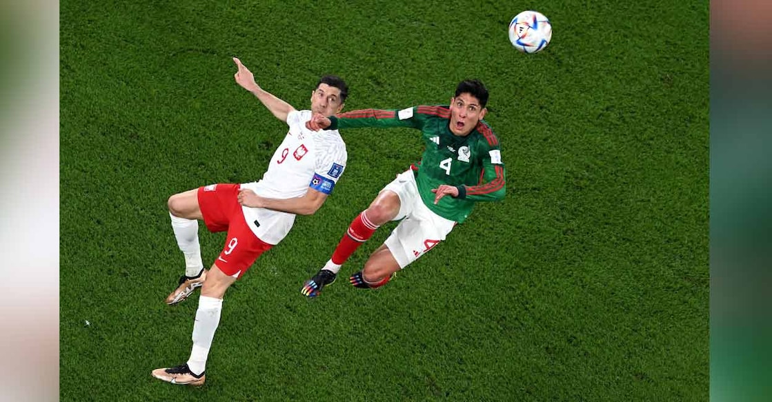Poland's Robert Lewandowski (left) and Mexico's Edson Alvarez eye the ball during their Group C match in the Qatar 2022 World Cup at Stadium 974 in Doha on Tuesday. Photo: AFP/ Kirill Kudryavtsev