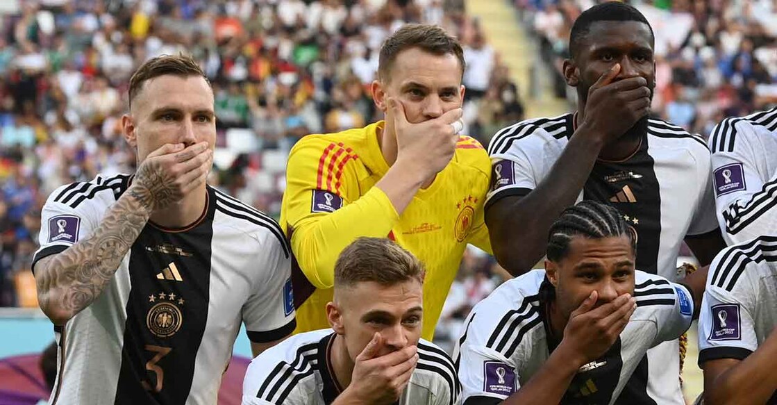 German players cover their mouths as they pose for a team photo. Photo: Reuters/Annegret Hilse