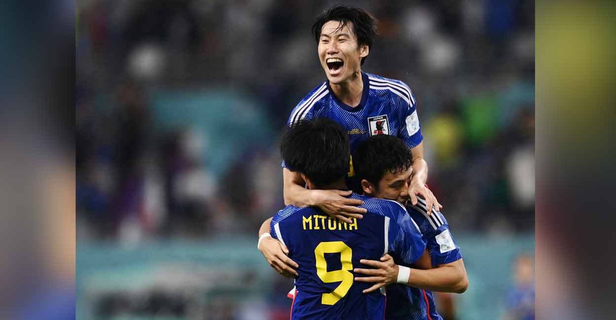 Japan's Kaoru Mitoma, Wataru Endo and Yuto Nagatomo celebrate after the match. Photo: Reuters/ Annegret Hilse 