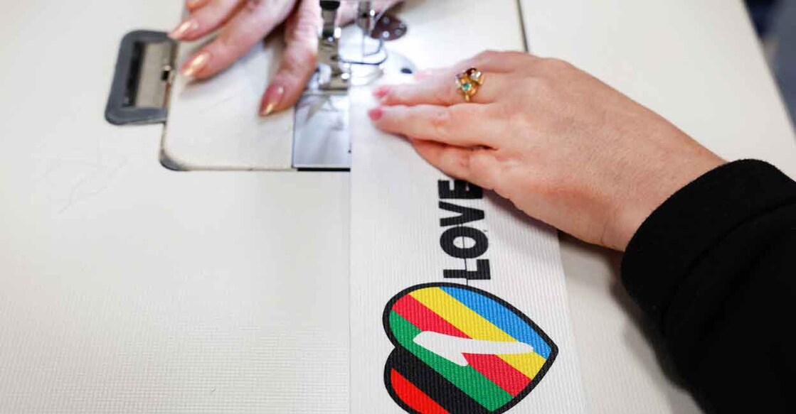 A woman sews Velcro on to a OneLove armband in Utrecht, the Netherlands, on Wednesday. Photo: Reuters